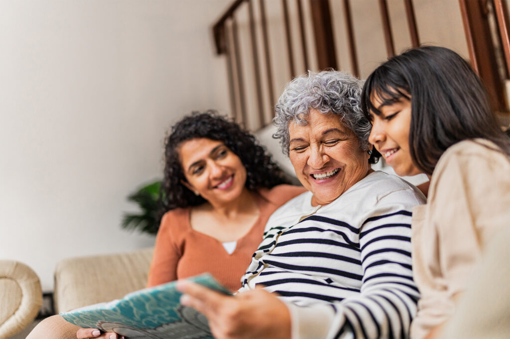 Elderly woman with grandchildren looking at tablet together