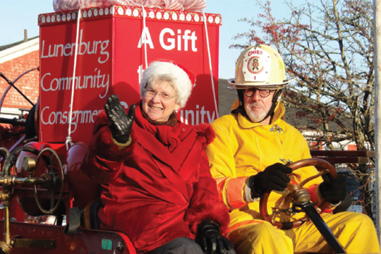 Cheryl Lamerson and husband Will Brooks greet the crowds while aboard an antique fire truck during last November’s Lunenburg Santa Parade.  Photo: Vicki Mossman-Conrad, Lunenburg