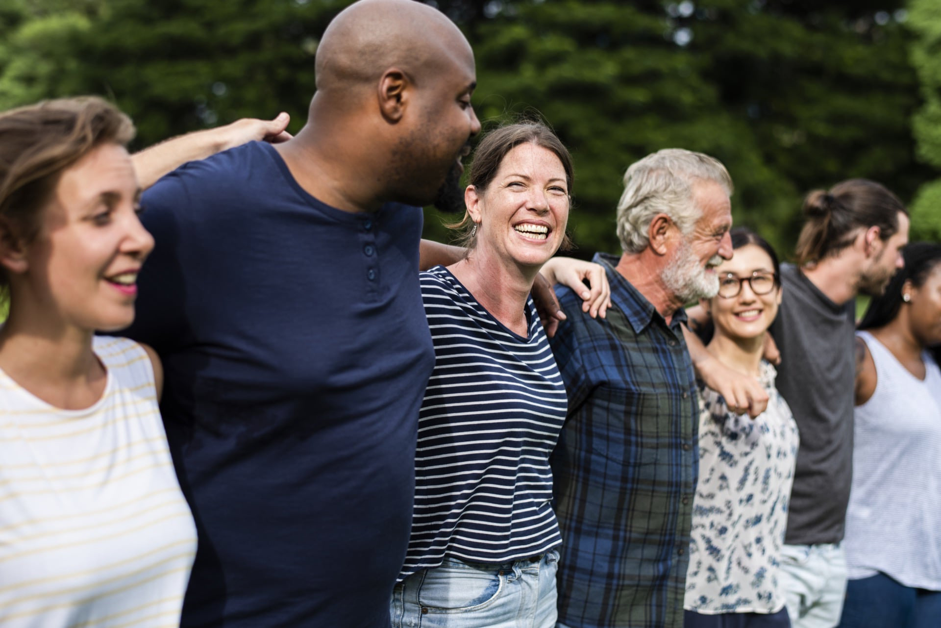 Group of lively people outside smiling