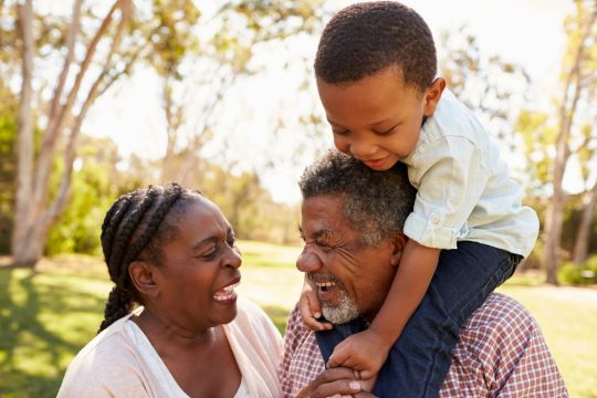 Grandparents and kid play outside